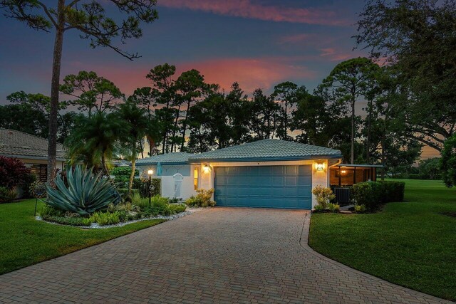 ranch-style home with a front yard and a garage