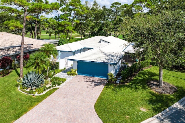 view of front of property with a front lawn and a garage