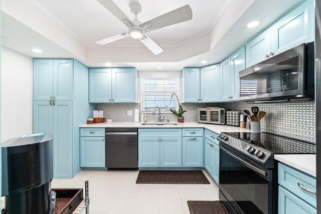 kitchen featuring ornamental molding, sink, backsplash, blue cabinetry, and stainless steel appliances