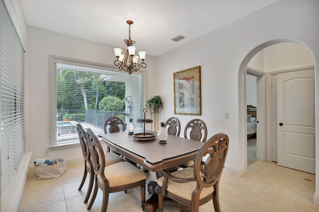 tiled dining space with a notable chandelier