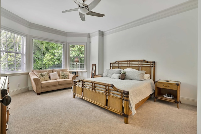 carpeted bedroom with ceiling fan and crown molding