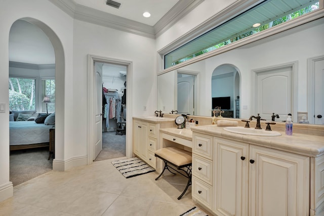 bathroom featuring crown molding, tile patterned flooring, and vanity