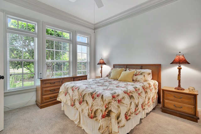 bedroom featuring light carpet, a ceiling fan, and crown molding