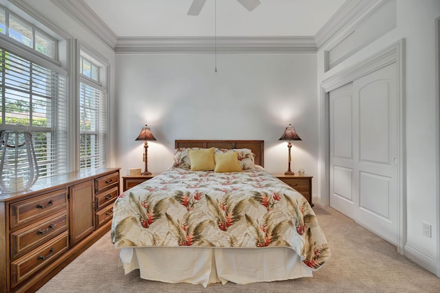 bedroom featuring ceiling fan, light colored carpet, and crown molding