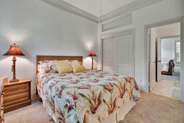 bedroom featuring light carpet, a closet, and ornamental molding