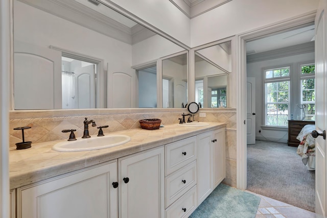 ensuite bathroom featuring double vanity, crown molding, a sink, and ensuite bathroom