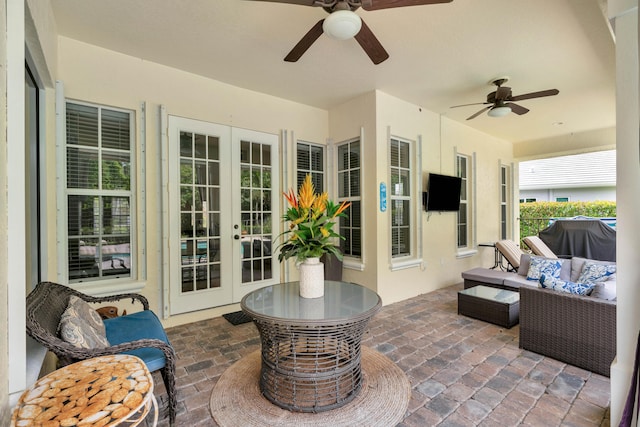 view of patio with ceiling fan, french doors, area for grilling, and an outdoor living space