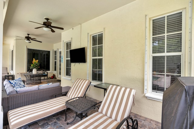 view of patio with ceiling fan and an outdoor living space