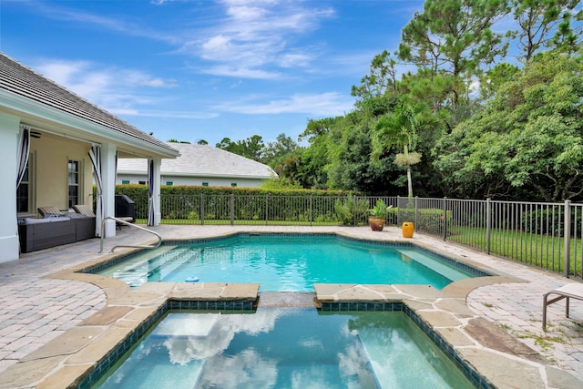 view of swimming pool with a pool with connected hot tub, a fenced backyard, and a patio