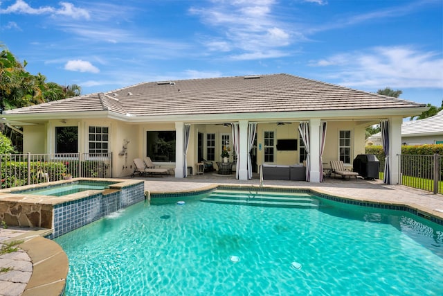 view of swimming pool with an in ground hot tub and a patio