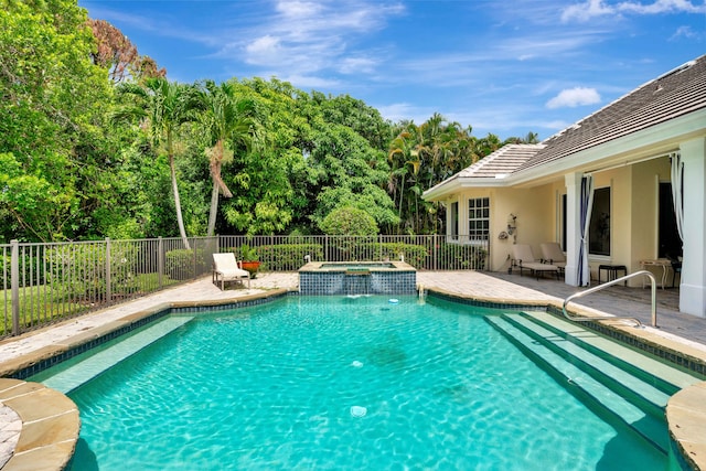 view of pool with an in ground hot tub and a patio