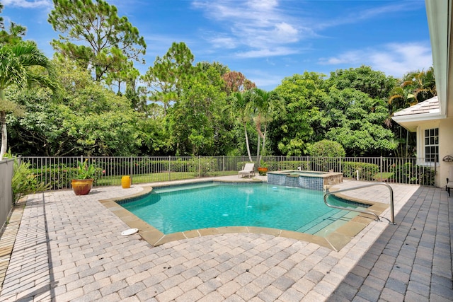 view of pool with a patio area and an in ground hot tub