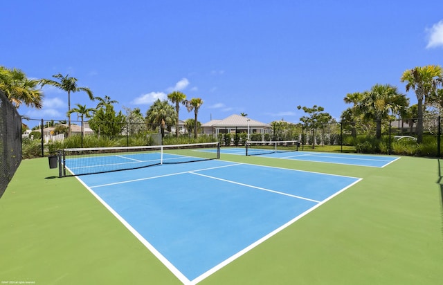 view of tennis court with fence