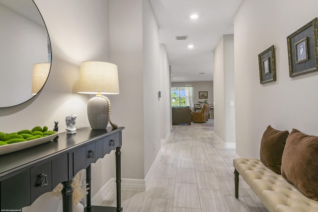 hallway with recessed lighting, visible vents, and baseboards