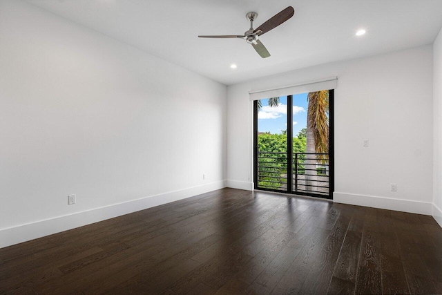 unfurnished room featuring dark wood-type flooring and ceiling fan