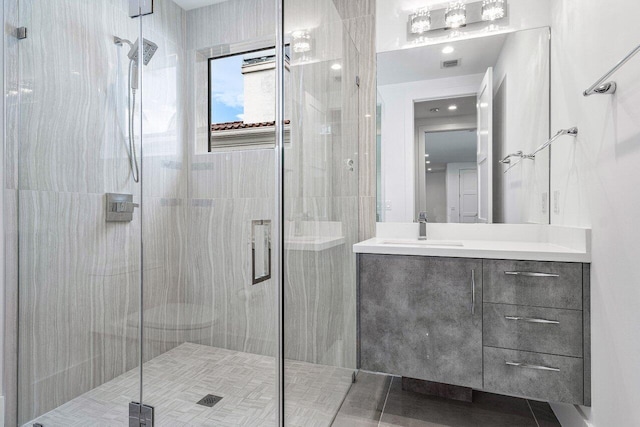 full bath featuring a shower stall, vanity, tile patterned floors, and visible vents