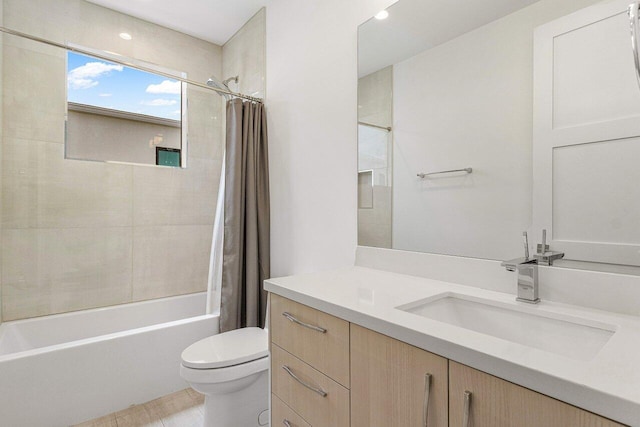 full bathroom featuring toilet, vanity, and shower / bathtub combination with curtain