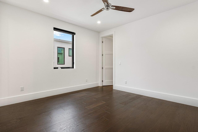 spare room with dark hardwood / wood-style floors and ceiling fan