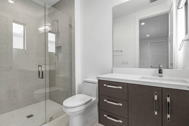 bathroom with toilet, vanity, recessed lighting, and a stall shower