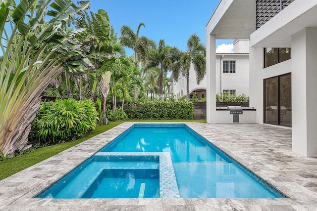 view of swimming pool featuring a patio and an in ground hot tub