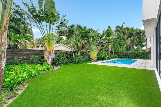 view of yard with a fenced in pool