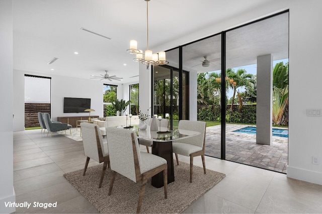 dining area with expansive windows and ceiling fan with notable chandelier