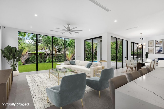 living area with recessed lighting, expansive windows, and a ceiling fan