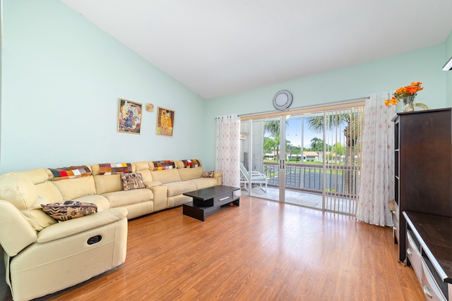 living room with high vaulted ceiling and wood-type flooring