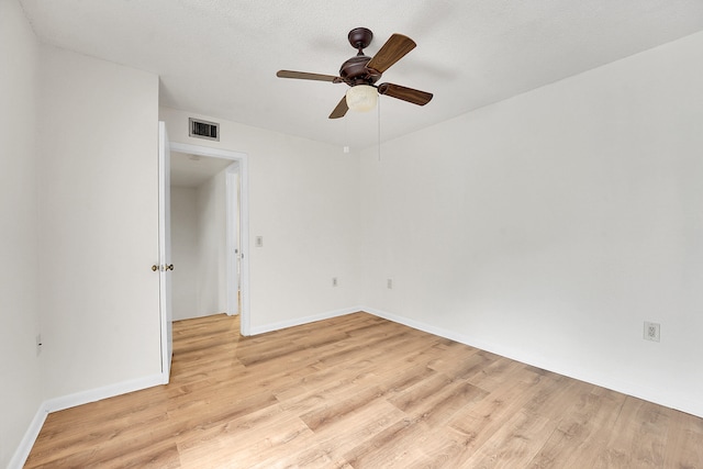 spare room with ceiling fan and light hardwood / wood-style floors