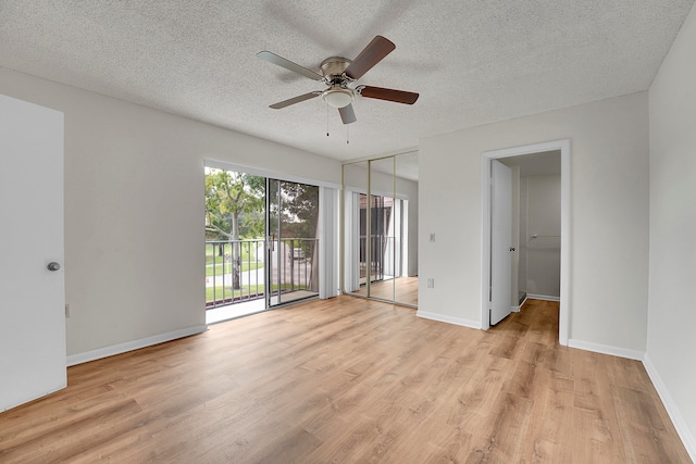 unfurnished bedroom featuring ceiling fan, light wood-type flooring, a closet, access to exterior, and a textured ceiling