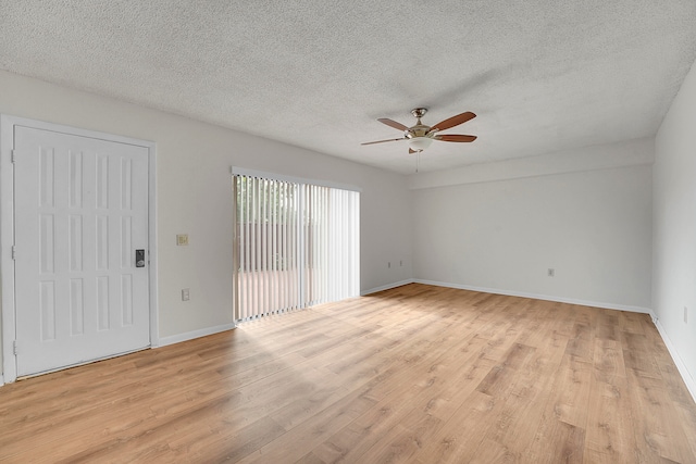 spare room with ceiling fan, light hardwood / wood-style flooring, and a textured ceiling