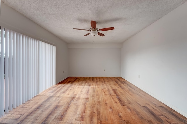 spare room with ceiling fan, light hardwood / wood-style flooring, and a textured ceiling