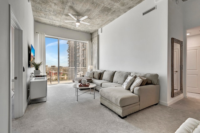 living room with ceiling fan and light carpet