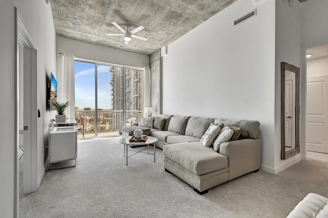 living room with visible vents, ceiling fan, and carpet floors