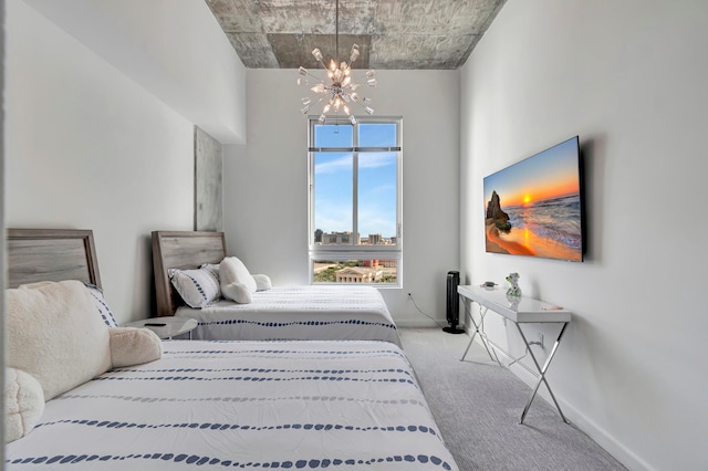 bedroom with carpet floors and a notable chandelier