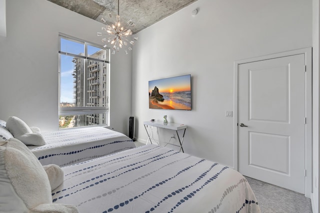 bedroom featuring multiple windows, a notable chandelier, and carpet floors