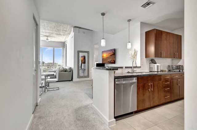 kitchen with backsplash, sink, dark stone countertops, dishwasher, and light colored carpet