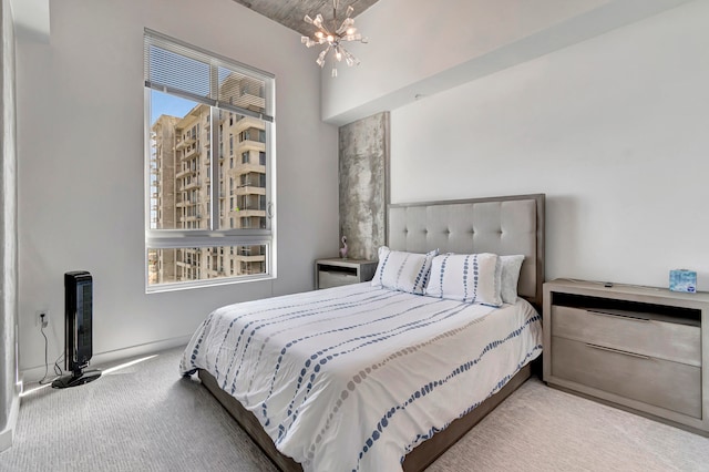 carpeted bedroom featuring a notable chandelier