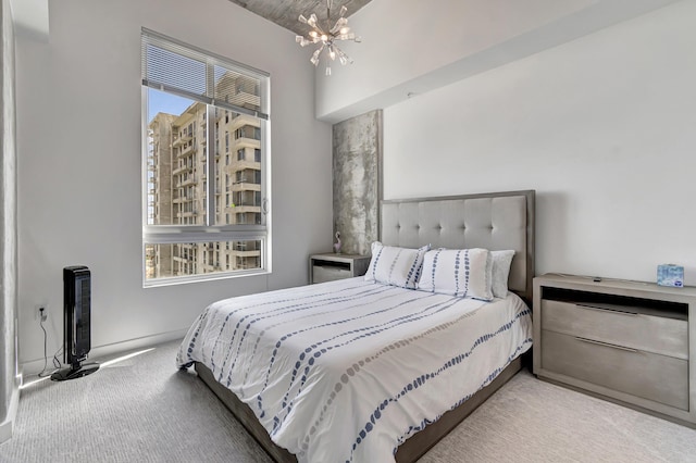 carpeted bedroom featuring a notable chandelier