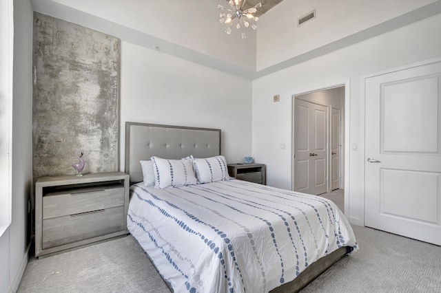 carpeted bedroom with a high ceiling, a notable chandelier, and visible vents