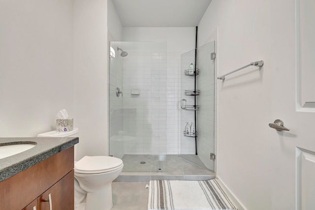 bathroom featuring tile patterned flooring, toilet, an enclosed shower, and vanity