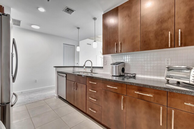 kitchen featuring dark stone counters, backsplash, sink, light carpet, and stainless steel appliances