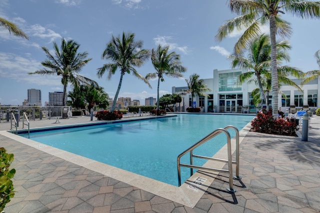 pool with a city view and a patio area