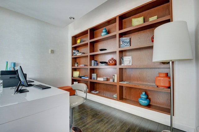 home office with dark hardwood / wood-style flooring