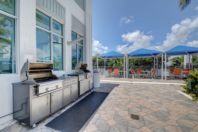 view of patio / terrace featuring a grill and an outdoor kitchen