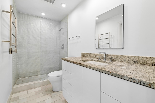 bathroom with vanity, toilet, tile patterned flooring, and a shower with door