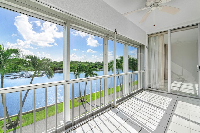 unfurnished sunroom with a water view and ceiling fan