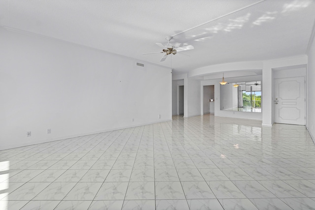 spare room featuring ceiling fan and a textured ceiling