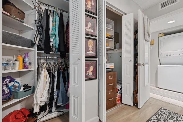 closet featuring stacked washer / dryer