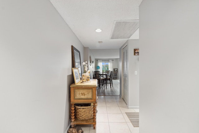 hallway featuring light tile patterned floors